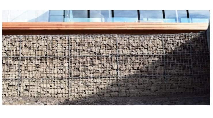 Gabion, comes from the Italian term for ‘cage’ and that is exactly what a gabion retaining wall is