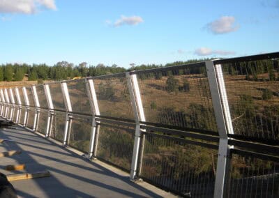 Protective mesh fencing installed on a bridge