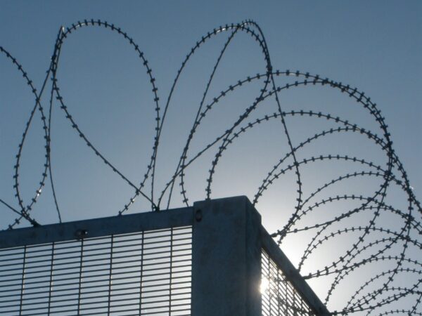 Concertina razor wire coils creating a high-security barrier